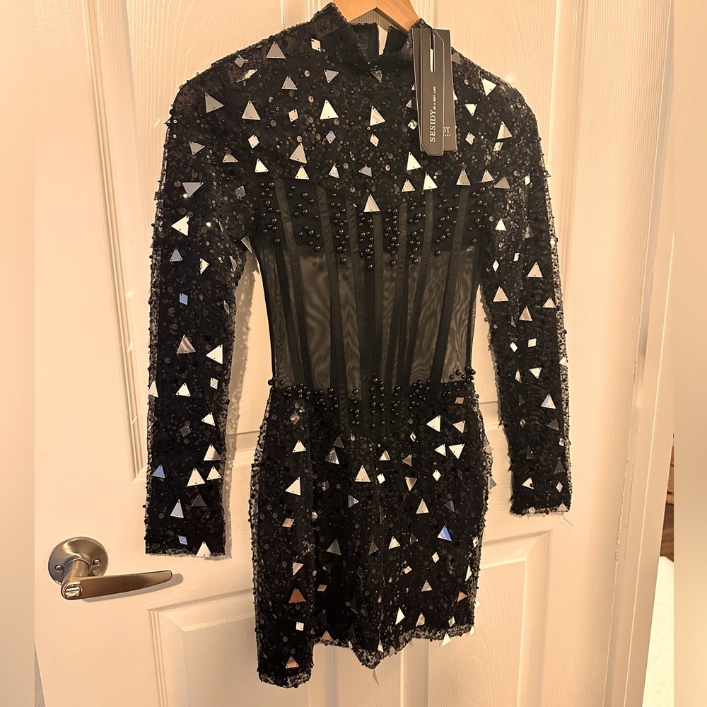 Sleek cocktail. Sheer with silver embellishment. Runs small. Tight fitting